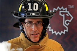 Steve Schwartz ’84 in firefighting gear with a smoke simulator.
